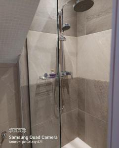 a shower with a glass door in a bathroom at Old Market Studio next to parking lot in Heraklio