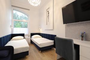 Łóżko lub łóżka w pokoju w obiekcie Dworek Różany Hotel & Restauracja