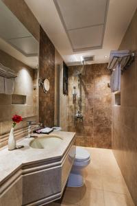 a bathroom with a sink and a toilet at Beach View Hotel in Dammam