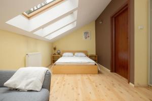 a attic bedroom with a bed and a skylight at Pine House by Sea in Pobierowo