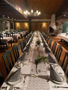 Sødorp Gjestgivergård Motell في فينسترا: طاولة طويلة في غرفة مع طاولات وكراسي