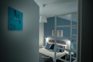 a bedroom with a mirror and a bed with pillows at Al Vicolo Comfort Room in SantʼAgata di Militello