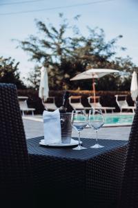 a table with two glasses and a bottle of wine at Villa Castiglione in Impruneta