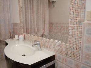 a bathroom with a sink and a mirror at Sirolo - Pesciolino Azzurro in Sirolo