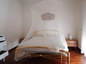 a bedroom with a bed with a mosquito net at Sirolo - Pesciolino Azzurro in Sirolo