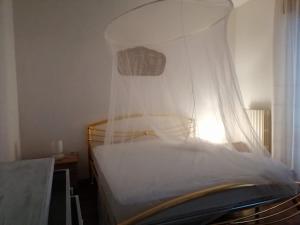 a bedroom with a bed with a mosquito net at Sirolo - Pesciolino Azzurro in Sirolo +2 photos