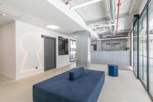 a room with a blue couch in the middle of it at Micampus Getafe in Getafe