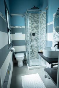 a bathroom with a shower and a toilet and a sink at Al Vicolo Comfort Room in SantʼAgata di Militello