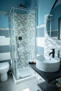 a bathroom with a shower with a sink and a toilet at Al Vicolo Comfort Room in SantʼAgata di Militello