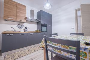 a kitchen with a table and a kitchen with a stove at Damilhouse 3 in Messina +10 photos