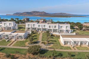 an aerial view of a house with the ocean in the background at Stunning Capo Falcone Charming Apartments 2 Bedrooms sleeps 6 in Stintino