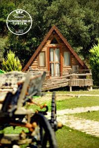 uma cabana de madeira com um banco à frente em Kazdaglari Ida Natura Bungalov Hotel em Akçay