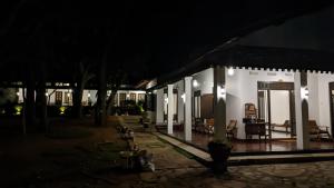 a building with chairs and tables at night at Verandas Trincomalee in Trincomalee