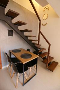 a dining room with a table and a staircase at FLAT W3 Norte in Brasilia