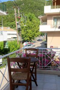 a table and a chair on a balcony with flowers at Yiampanaki in Vasiliki