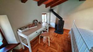 a room with a desk and a wood stove at Il Bordone del Pellegrino in Terenzo