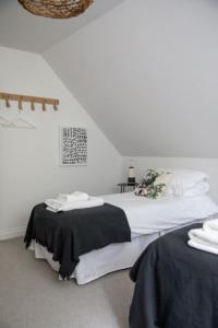 a bedroom with a bed with black and white sheets at Highfield in Lauder