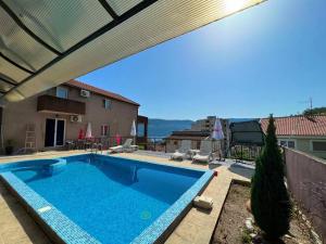a large swimming pool with a retractable roof at Apartments Lav Costas in Herceg-Novi