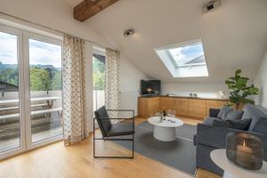 a living room with a couch and a tv at Landhaus Ohrwumslar in Oberstdorf