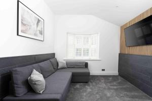 a living room with a couch and a flat screen tv at Stunning new fully renovated flat in Marazion in Marazion