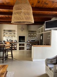 a large living room with a table and a ceiling at Hartebeeskraal Selfcatering cottage in Paarl