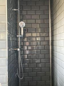 a shower with a basketball hoop in a brick wall at Bryn Mair cottage overlooking Snowdon in Caernarfon