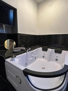 a large white bath tub in a bathroom at B&B Residenza De Rose in Cosenza