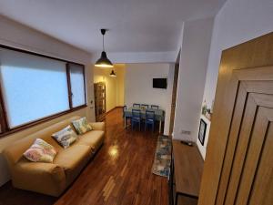 a living room with a couch and a table at Appartamento in centro a Rocca di Cambio in Rocca di Cambio