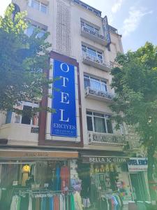 a store with a blue sign on the side of a building at Fatih Hotel Erciyes in Istanbul