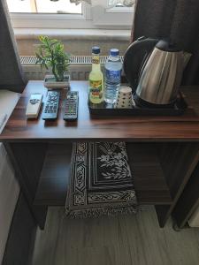 a wooden table with two bottles of water and remote controls at Fatih Hotel Erciyes in Istanbul
