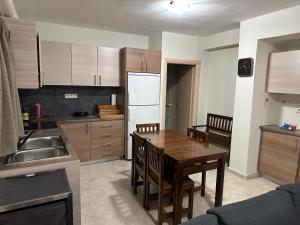 a kitchen with a wooden table and a kitchen with a sink at Luxury Villa Magic View 4U - katarina in Kineta