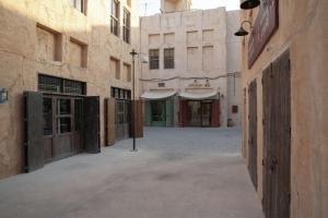 an empty street in an alley with buildings at Al Seef Heritage Hotel Dubai, Curio Collection by Hilton in Dubai