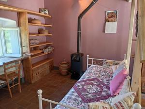 a bedroom with a bed and a wood stove at Agriturismo Cà del Lupo in Pontremoli