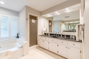 a bathroom with a tub and a large mirror at Lake Nottely Escape in Mashburn Mill +53 photos