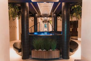 a lobby with a hot tub and two columns at Hotel Binkowski in Kielce