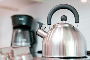 a silver tea kettle sitting on a kitchen counter at Luxury Living City Views DC in Arlington