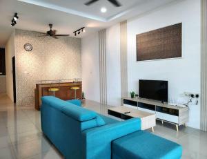 un soggiorno con divano blu e TV di 30 Tasek East - KKS Standard Collection a Ipoh