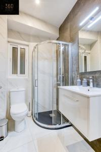 a bathroom with a shower and a toilet and a sink at Gzira's Seashore Stayaway close to Manuel Island in Il-Gżira