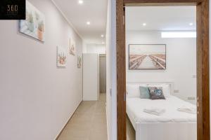a bedroom with a bed and a hallway at Gzira's Seashore Stayaway close to Manuel Island in Il-Gżira