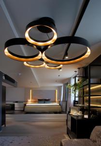 a room with a bed and a chandelier at Hotel Klaus K in Helsinki