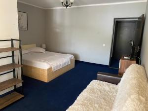 a small bedroom with a bed and a window at CHALET Orsova in Orşova