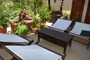two chairs and a table in a room with plants at VILLA AVATOS - Near to the Port of Rafina and the Airport of Athens in Áyios Spirídhon