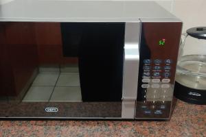a microwave oven sitting on top of a counter at Kingfisher 15 - Home away from home in Margate