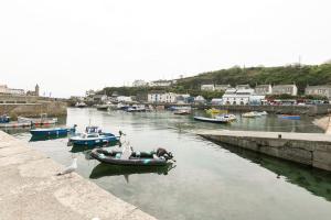 a group of boats in a body of water at Kota Restaurant & Rooms in Porthleven