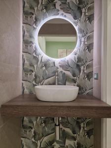 a bathroom with a sink and a mirror at ondina house in Giardini Naxos