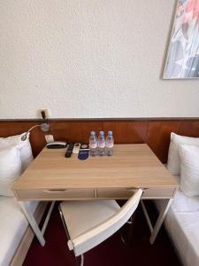 a table in a room with two water bottles on it at Azurene Royal Hotel in Cannes