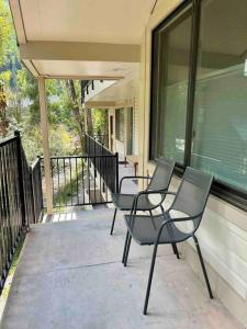 three chairs sitting on the porch of a house at Luxury Downtown Telluride - Creekside Condo - Walk to Chair 7! in Telluride