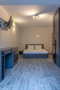 a bedroom with a bed and a desk in a room at Medusa Rooms in Kallithea Halkidikis