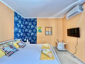 a bedroom with a large bed and a tv at Apartments Lav Costas in Herceg-Novi +107 photos