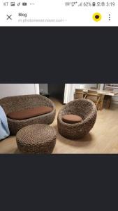 a picture of two wicker chairs in a room at Private Mosageum in Yeosu